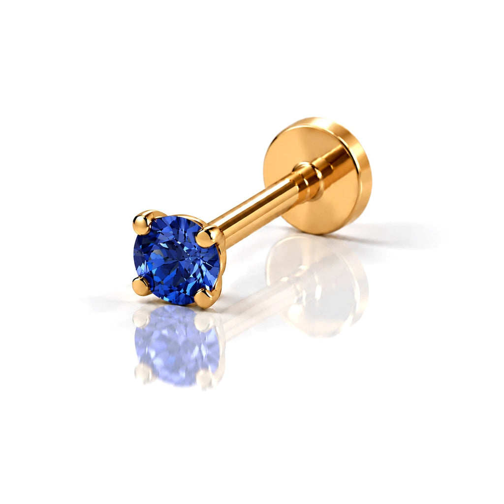 June Griffe Deep Blue piercing in yellow titanium