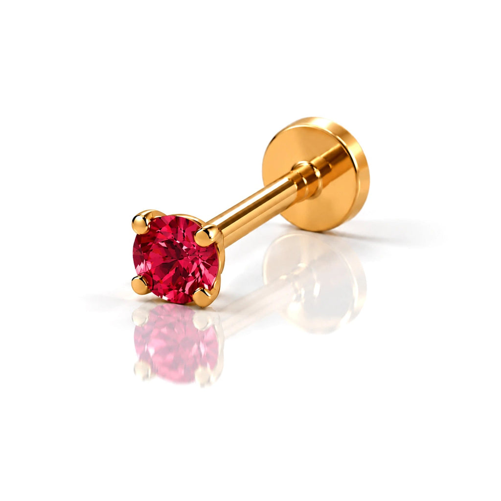 June Griffe Ruby Red piercing in yellow titanium
