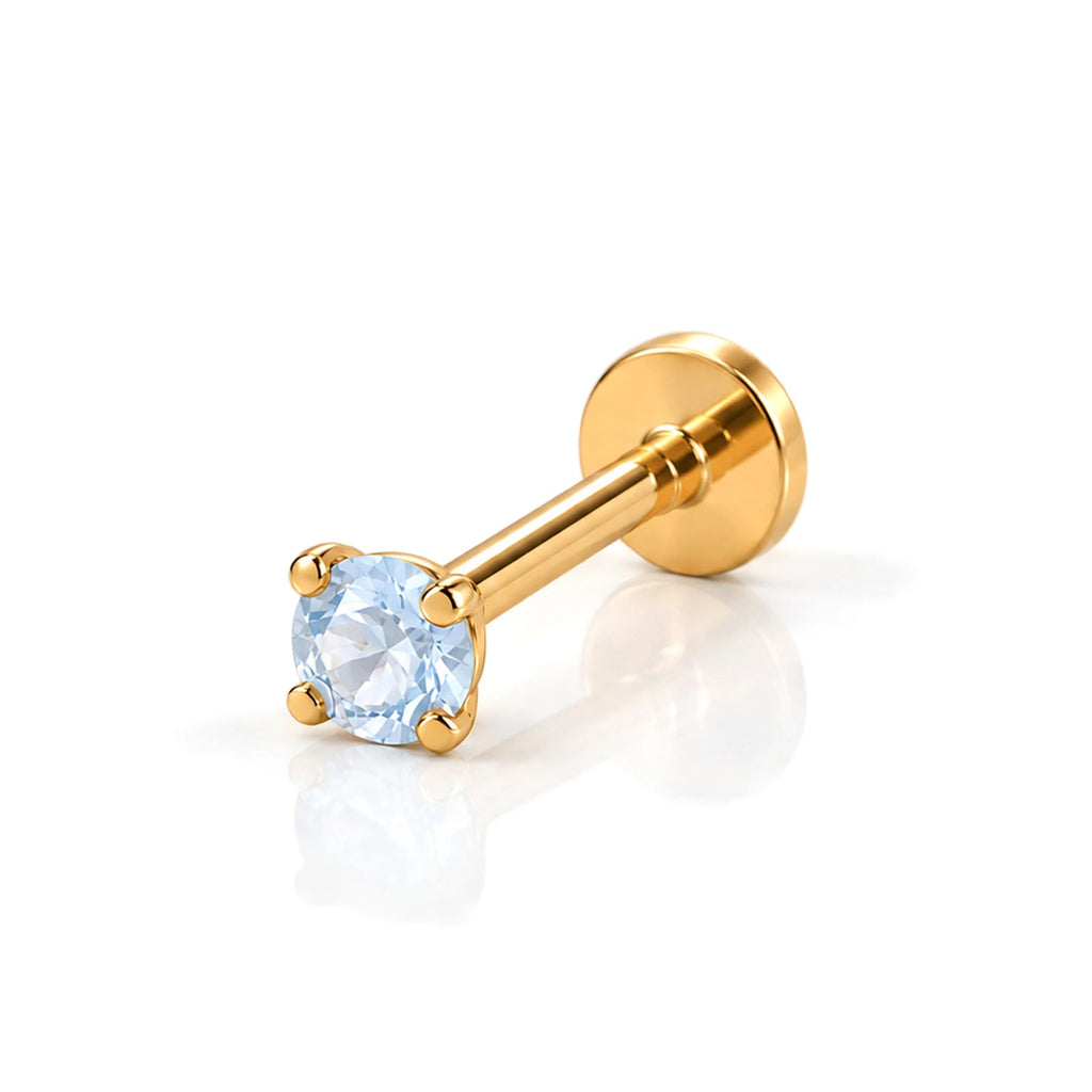 June Griffe Sky Blue piercing in yellow titanium